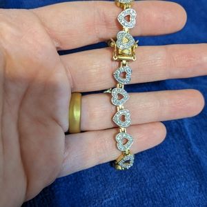 Gold colored bracelet with sparkly gem hearts